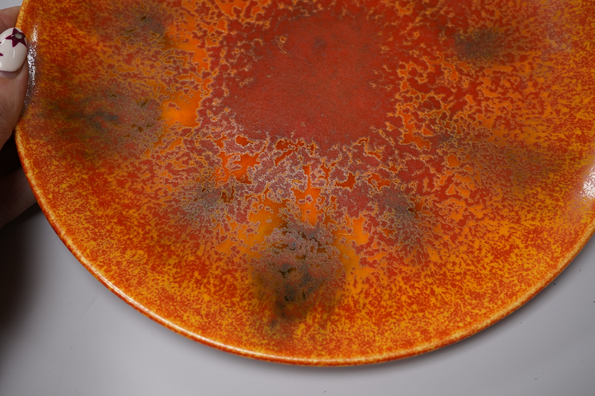 A Pilkingtons orange lustre plate, stamped to the base, 21cm in diameter